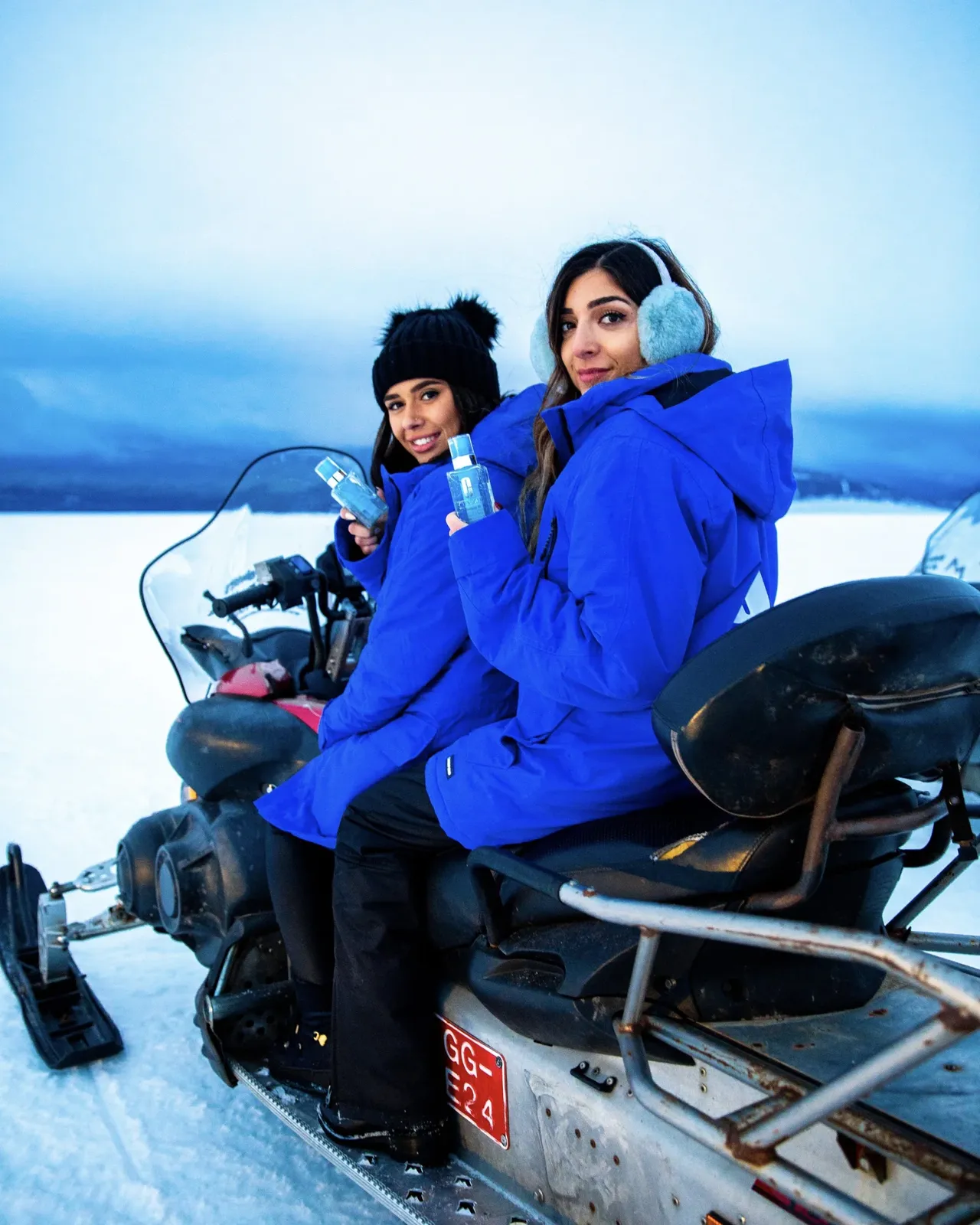 Two women in winter coats on a snowmobile in Iceland